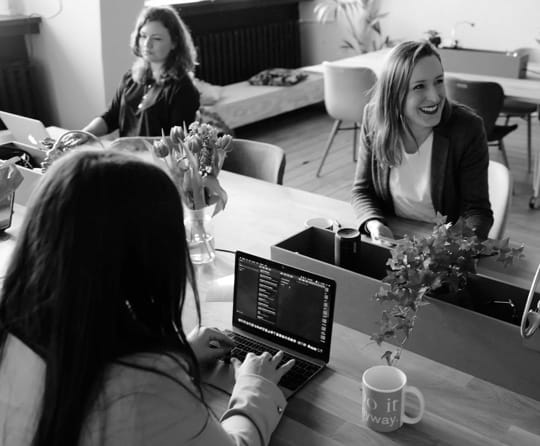 Three people working in an office